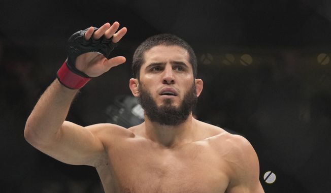 Islam Makhachev of Russia celebrates after he beats Alex Volkanovski of Australia in the UFC lightweight championship fight during UFC 294, at the Ethihad Arena in Abu Dhabi, United Arab Emirates, Oct. 21, 2023. (AP Photo/Kamran Jebreili, File)
