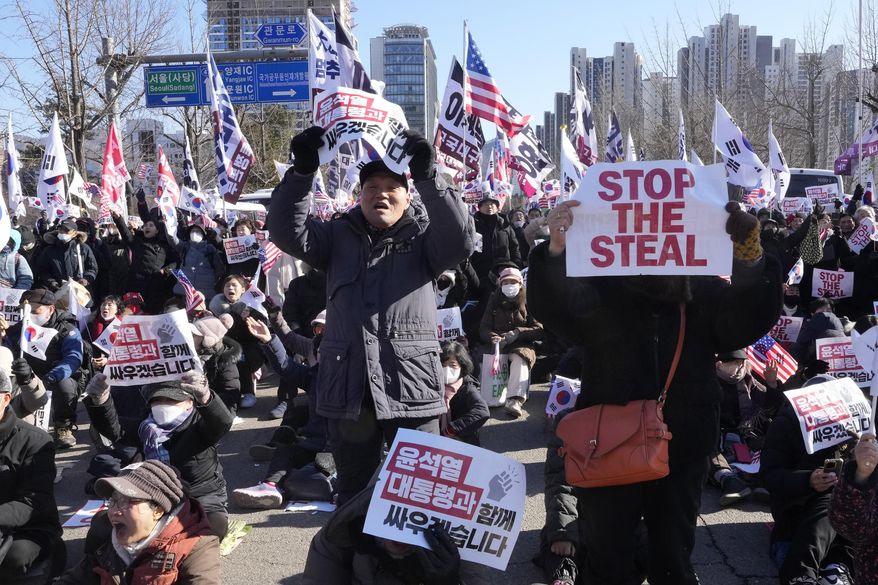 Supporters of impeached South Korean President Yoon Suk Yeol stage a rally to oppose his impeachment near the Corruption Investigation Office for High-ranking Officials in Gwacheon, South Korea, Wednesday, Jan. 15, 2025. The signs read "We will fight together with President Yoon Suk Yeol." (AP Photo/Ahn Young-joon)