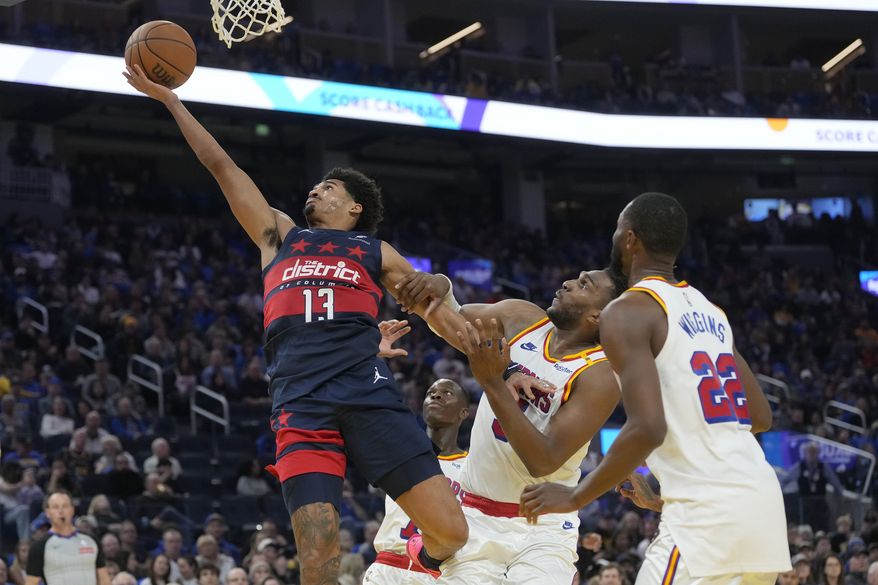 Washington Wizards guard Jordan Poole (13) shoots during an NBA basketball game against the Golden State Warriors in San Francisco, Saturday, Jan. 18, 2025. (AP Photo/Jeff Chiu)