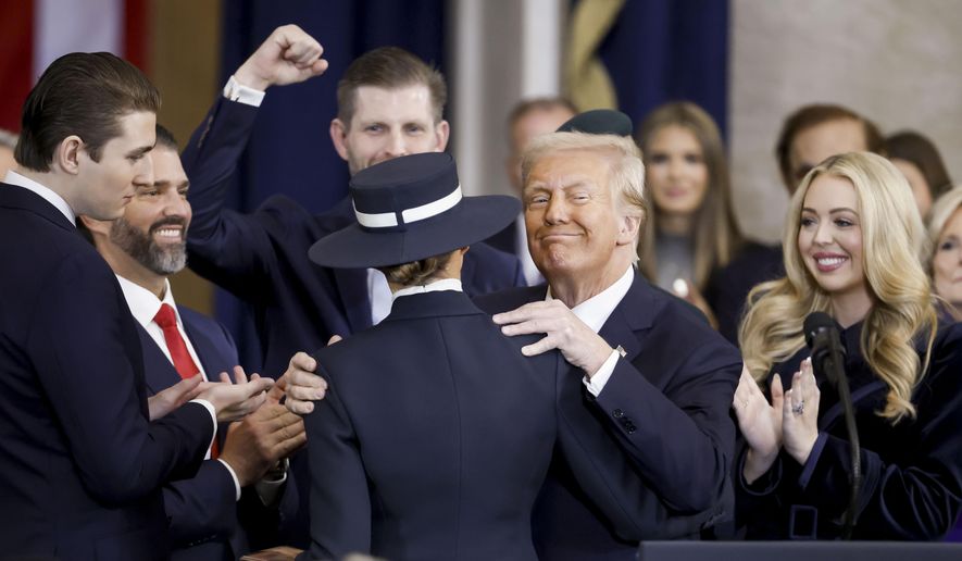 President Donald Trump with his wife first lady Melanie Trump, as well as his sons Barron Trump, Donald Trump, Jr., Eric Trump, left, and daughter Tiffany Trump, right, after taking the oath of office during the 60th Presidential Inauguration in the Rotunda of the U.S. Capitol in Washington, Monday, Jan. 20, 2025. (Shawn Thew/Pool photo via AP)