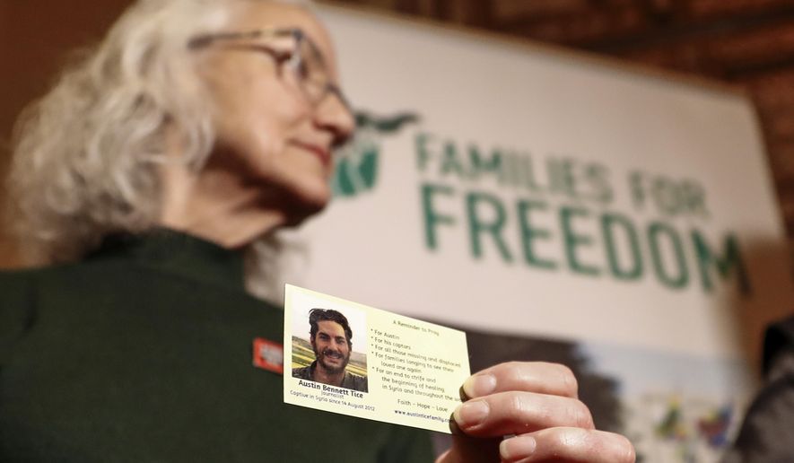 Debra Tice, the mother of American journalist Austin Tice, who went missing in Syria in 2012, holds a card with a picture of her son during a press conference in Damascus, Syria, Monday, Jan. 20, 2025. (AP Photo/Omar Sanadiki)