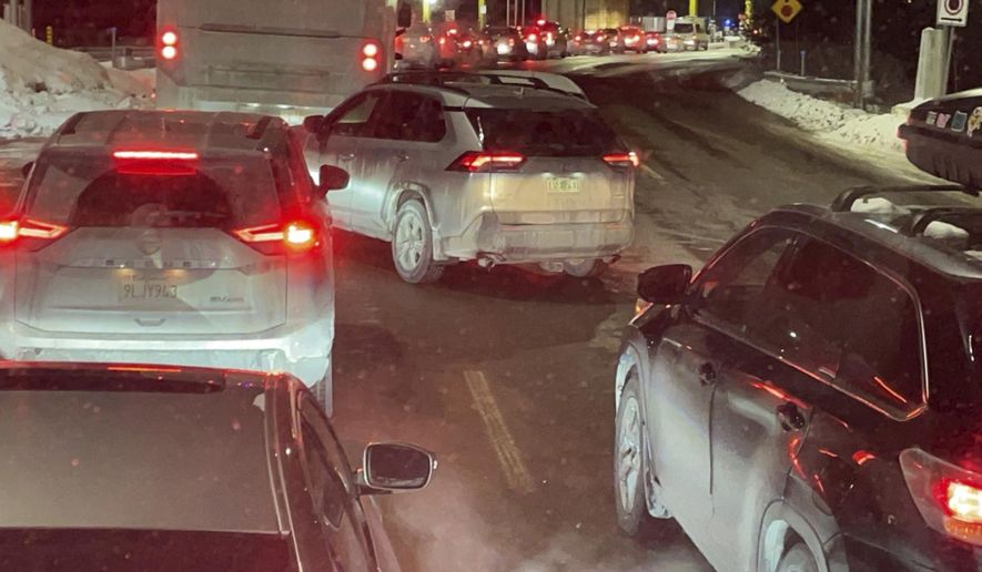 Cars are backed up at the US-Canada border in Stanstead, Quebec, after a shooting involving a U.S. Border Patrol agent in Coventry, Vt., Monday, Jan. 20, 2025. (AP Photo/Chloe Jones)