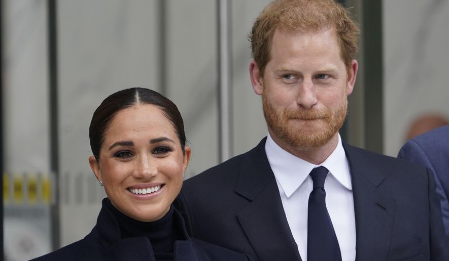 Meghan Markle and Prince Harry pose for pictures after visiting the observatory in One World Trade in New York, Sept. 23, 2021.(AP Photo/Seth Wenig, File)