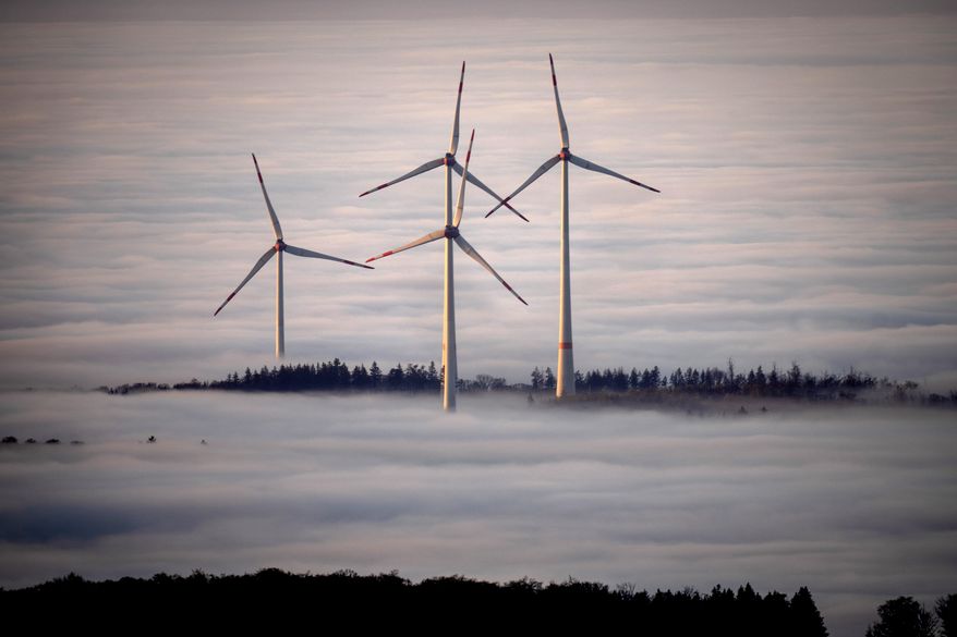FILE - Wind turbines are surrounded by fog in the Taunus region near Frankfurt, Germany, Nov. 10, 2024. (AP Photo/Michael Probst, File)