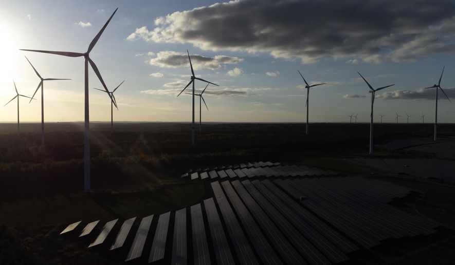 FILE - Wind turbines spin at the Klettwitz Nord solar energy park near Klettwitz, Germany, Oct. 15, 2024. (AP Photo/Matthias Schrader, File)