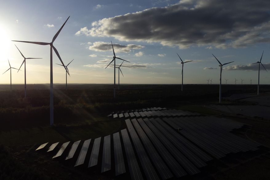 FILE - Wind turbines spin at the Klettwitz Nord solar energy park near Klettwitz, Germany, Oct. 15, 2024. (AP Photo/Matthias Schrader, File)
