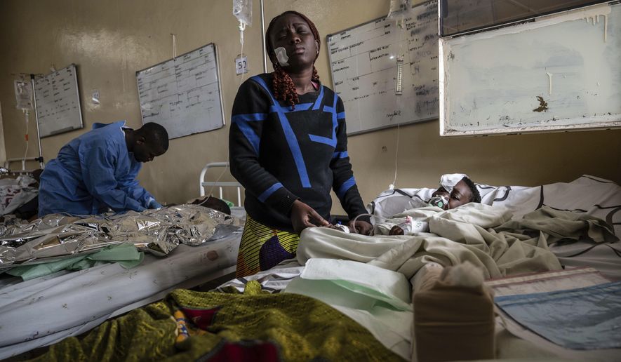 Mariam Nasibu stands by her 10-year-old daughter Deborah, who was wounded in the fighting between M23 rebels and Congolese armed forces, in Goma, Democratic Republic of the Congo, Thursday, Jan. 23, 2025. (AP Photo/Moses Sawasawa)