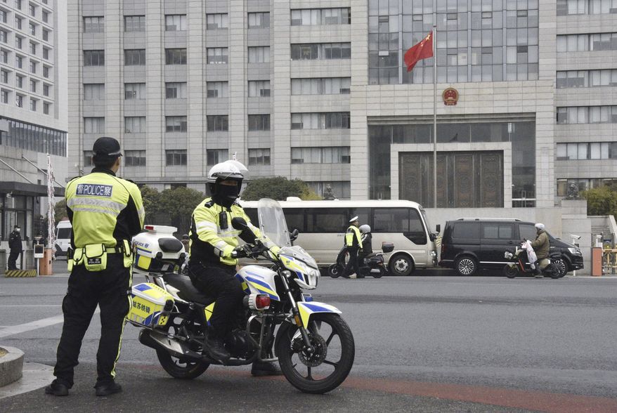 Police officers patrol at the Jiangsu Suzhou Intermediate People's Court in Suzhou, west of Shanghai, China, Thursday, Jan. 23, 2025. (Tomoya Shibata/Kyodo News via AP)