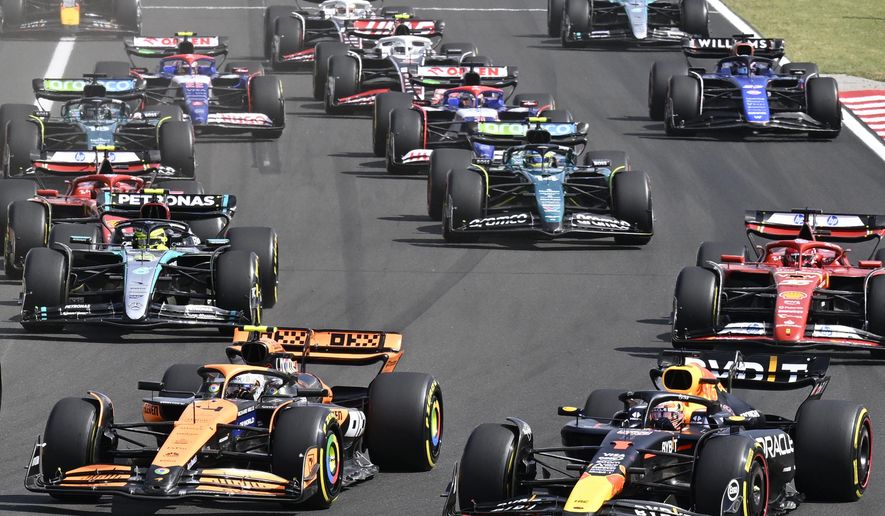 Drivers with their F1 cars start for the Hungarian Formula One Grand Prix race at the Hungaroring racetrack in Mogyorod, Hungary, Sunday, July 21, 2024. (AP Photo/Denes Erdos, File)