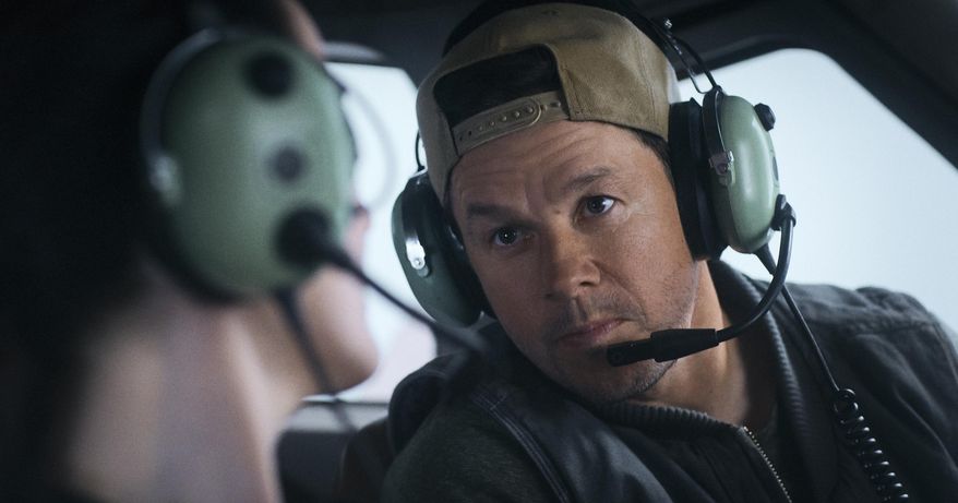 This image released by Lionsgate shows Michelle Dockery, left, and Mark Wahlberg in a scene from "Flight Risk." (Lionsgate via AP)