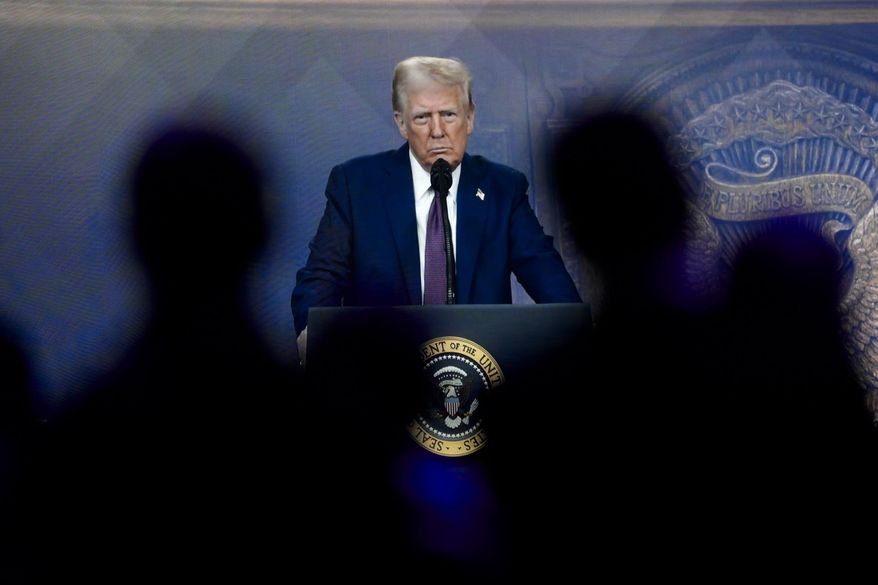 Attendees listen to a virtual speech delivered by U.S. president Donald Trump, at the Annual Meeting of World Economic Forum in Davos, Switzerland, Thursday, Jan. 23, 2025. (AP Photo/Markus Schreiber)
