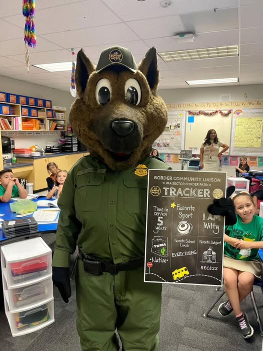 Tracker, the German shepherd mascot for the Border Patrol, visits Gowan Science Academy. (Image: U.S. Border Patrol Yuma Sector's Facebook page)