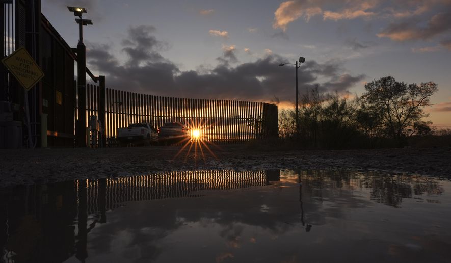 A Border Patrol agent keeps watch along the border wall at sunset, Tuesday, Jan. 21, 2025, in Hidalgo, Texas. (AP Photo/Eric Gay)