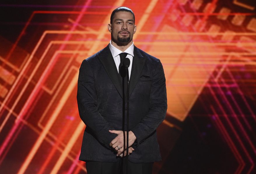 Roman Reigns presents the best coach award at the ESPY Awards on Wednesday, July 10, 2019, at the Microsoft Theater in Los Angeles. (Photo by Chris Pizzello/Invision/AP, File)