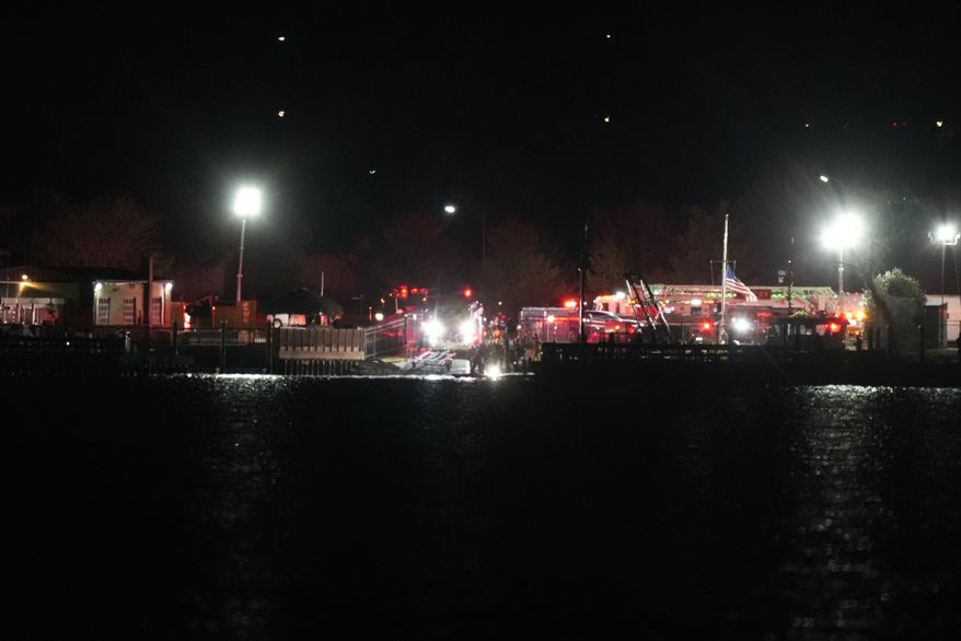 A view of emergency response looking from Arlington, Va., south of Ronald Reagan Washington National Airport, across the Potomac River toward the District of Columbia, Wednesday, Jan. 29, 2025. (AP Photo/Alex Brandon)