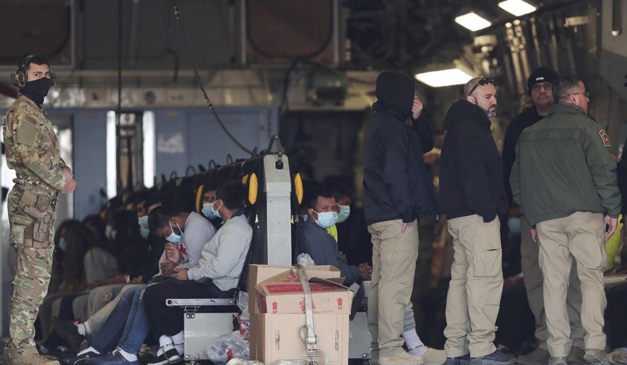 Migrants sit on a military aircraft at Fort Bliss in El Paso, Texas, Thursday, Jan. 30, 2025, awaiting their deportation to Guatemala. (AP Photo/Christian Chavez) ** FILE **