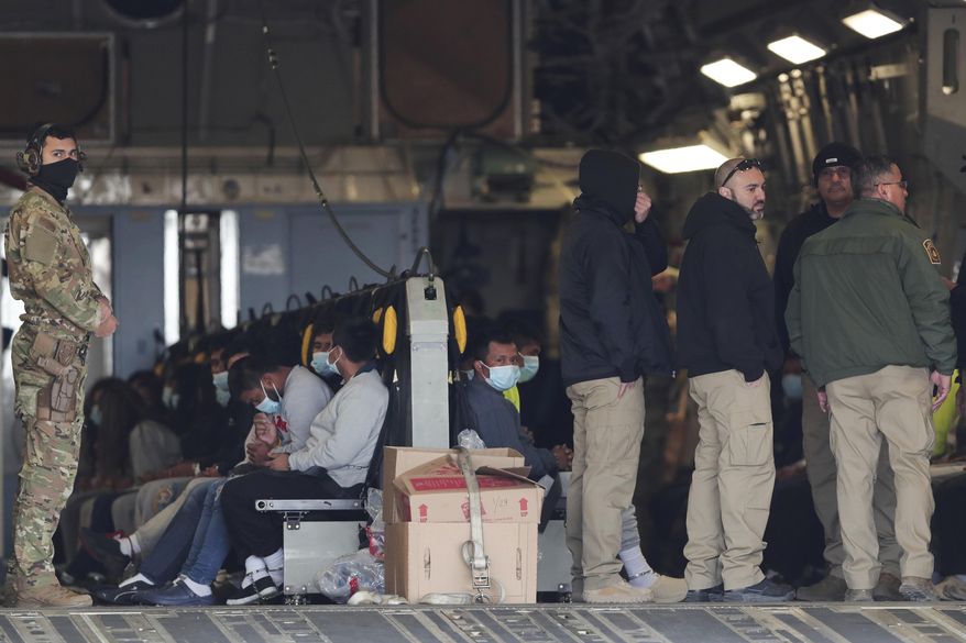 Migrants sit on a military aircraft at Fort Bliss in El Paso, Texas, Thursday, Jan. 30, 2025, awaiting their deportation to Guatemala. (AP Photo/Christian Chavez) ** FILE **