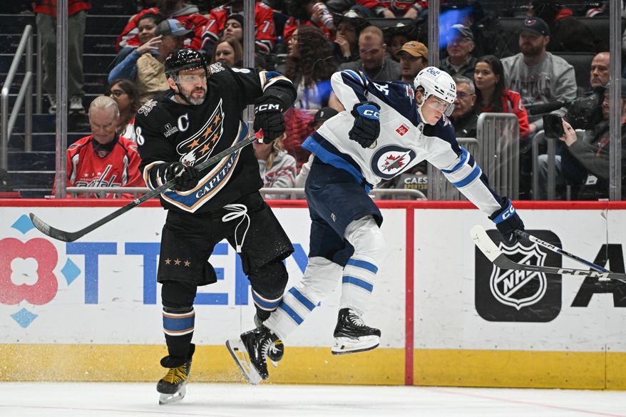 Washington Capitals left wing Alex Ovechkin (8) putting a hit on Winnipeg Jets center Rasmus Kupari (15) during the first period of an NHL game at Capital One Arena in Washington D.C., February 1, 2025. (Photo for the Washington Times)