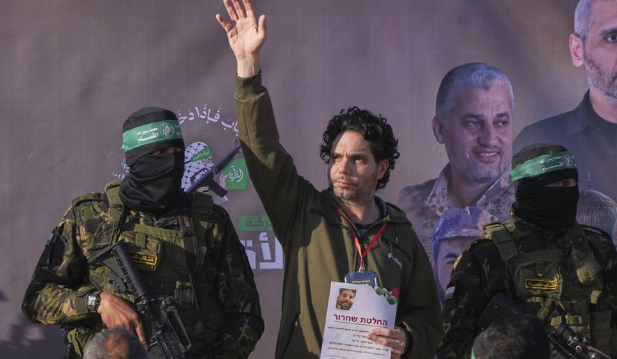 Israeli Ofer Kalderon who has been held hostage by Hamas in Gaza since October 7, 2023, waves before being handed over to the Red Cross by Hamas fighters in Khan Younis, southern Gaza Strip, Saturday Feb. 1, 2025. Photo/Abdel Kareem)