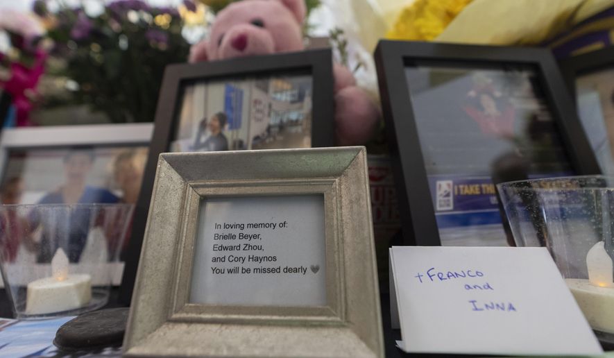 A memorial is seen along the boards at MedStar Capitals Iceplex Sunday, Feb. 2, 2025, in Arlington, Va., for the figure skaters who were among the 67 victims of a mid-air collision between an Army helicopter and an American Airlines flight from Kansas. (AP Photo/Carolyn Kaster)
