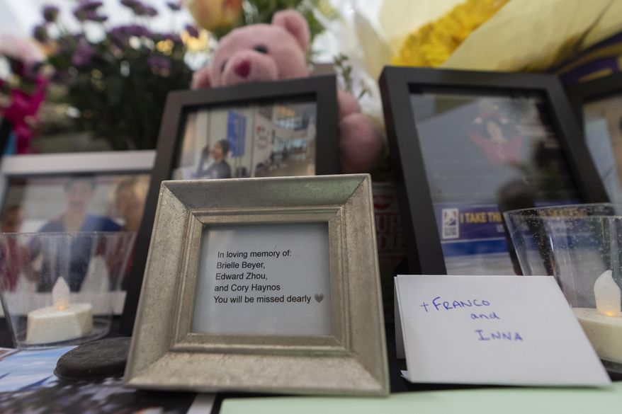 A memorial is seen along the boards at MedStar Capitals Iceplex Sunday, Feb. 2, 2025, in Arlington, Va., for the figure skaters who were among the 67 victims of a mid-air collision between an Army helicopter and an American Airlines flight from Kansas. (AP Photo/Carolyn Kaster)