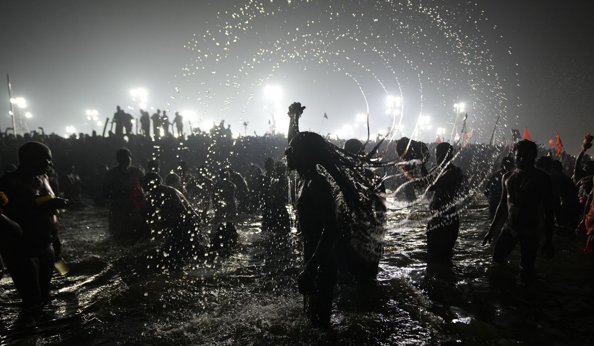 NextImg:Hindu ascetic rising from the river after a holy dip is emblematic of Maha Kumbh festival in India