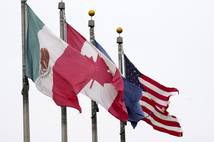 The flags of Mexico, Canada and the United States are shown near the Ambassador Bridge, Monday, Feb. 3, 2025, in Detroit. (AP Photo/Paul Sancya)
