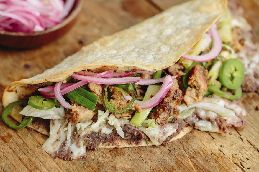 This image released by Milk Street shows a recipe for tlayudas. (Milk Street via AP)