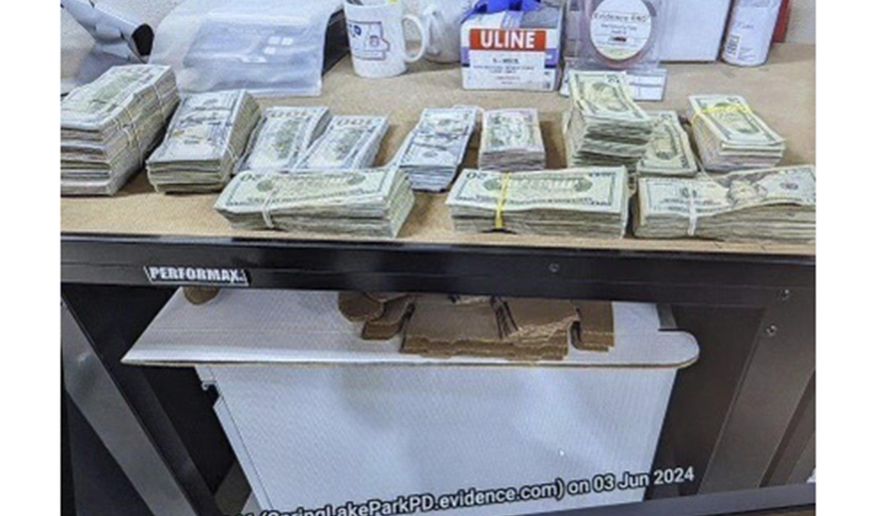 This photo supplied by the U.S. Attorney's Office for Minnesota shows cash from a bag that was left at the home of a juror in a massive fraud case, June 2, 2024, outside Minneapolis, Minn. (U.S. Attorney's Office for Minnesota via AP, File)