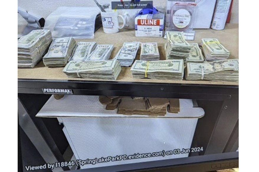 This photo supplied by the U.S. Attorney's Office for Minnesota shows cash from a bag that was left at the home of a juror in a massive fraud case, June 2, 2024, outside Minneapolis, Minn. (U.S. Attorney's Office for Minnesota via AP, File)