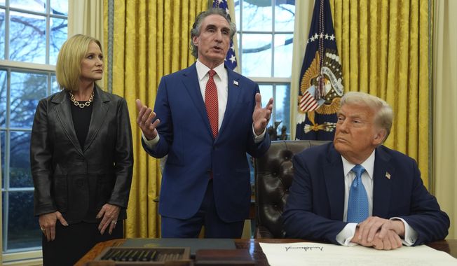 Interior Secretary Doug Burgum speaks as his wife Kathryn and President Donald Trump listen, in the Oval Office of the White House, Friday, Jan. 31, 2025, in Washington. (AP Photo/Evan Vucci) **FILE**