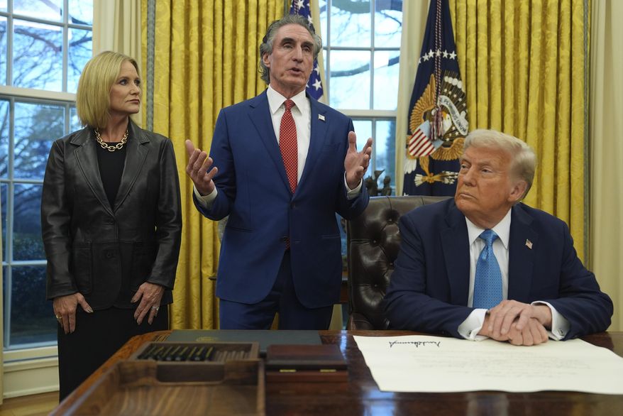 Interior Secretary Doug Burgum speaks as his wife Kathryn and President Donald Trump listen, in the Oval Office of the White House, Friday, Jan. 31, 2025, in Washington. (AP Photo/Evan Vucci) **FILE**