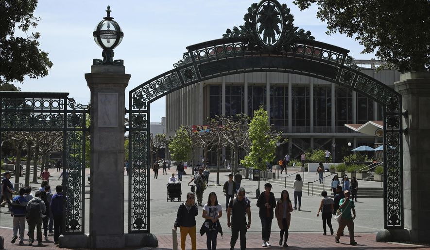 FILE - Students walk past Sather Gate on the University of California at Berkeley campus in Berkeley, Calif., May 10, 2018. (AP Photo/Ben Margot, File)