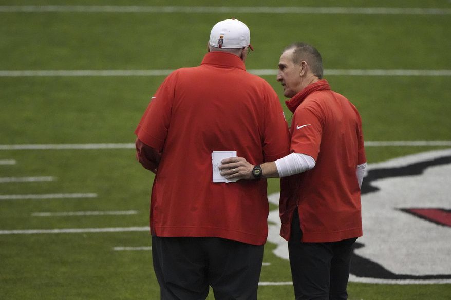 Kansas City Chiefs head coach Andy Reid, left, and Kansas City Chiefs defensive coordinator Steve Spagnuolo talk during the team's NFL football practice Thursday, Jan. 23, 2025, in Kansas City, Mo. (AP Photo/Charlie Riedel)