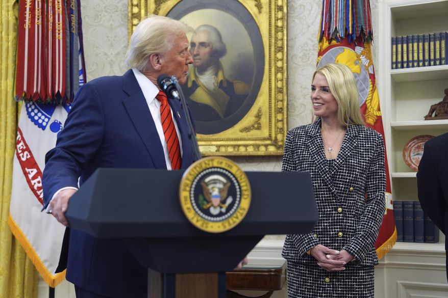 President Donald Trump welcomes Pam Bondi before she is sworn in as attorney general by Supreme Court Associate Justice Clarence Thomas, in the Oval Office of the White House, Wednesday, Feb. 5, 2025, in Washington. (AP Photo/Evan Vucci)