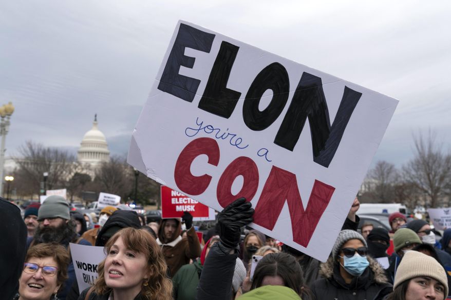 People protest during a rally against Elon Musk outside the U.S. Department of Labor in Washington, Wednesday, Feb. 5, 2025. (AP Photo/Jose Luis Magana)