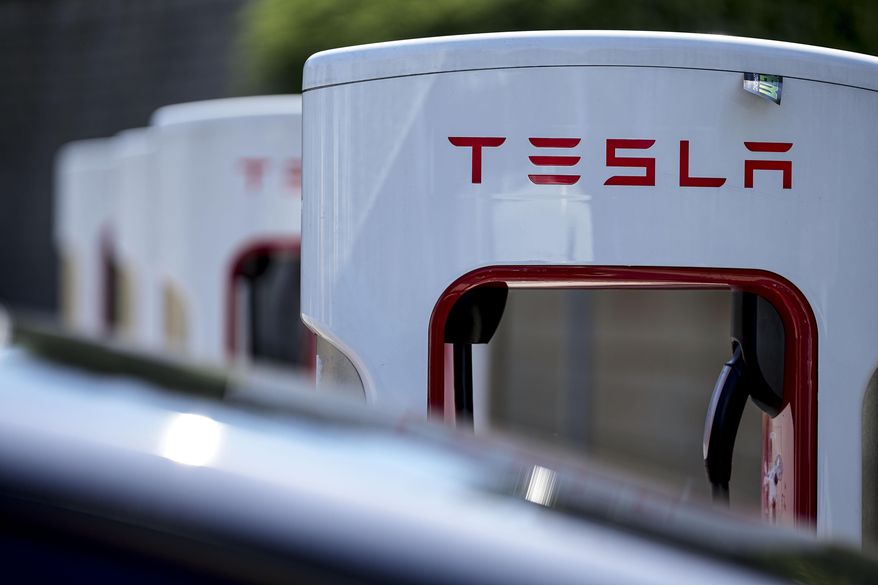 A Tesla electric vehicle charging station is seen, Sept. 28, 2023, in Woodstock, Ga. (AP Photo/Mike Stewart, File)