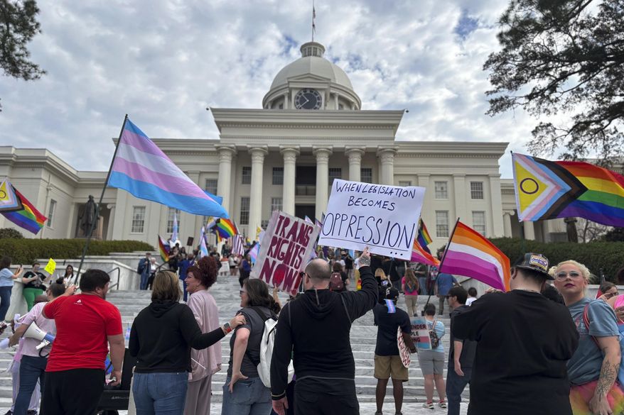 Demonstrators march to the Alabama Capitol in Montgomery, Ala., on Feb. 5, 2025 to protest bills that would impact transgender people. (AP Photo/Kim Chandler)