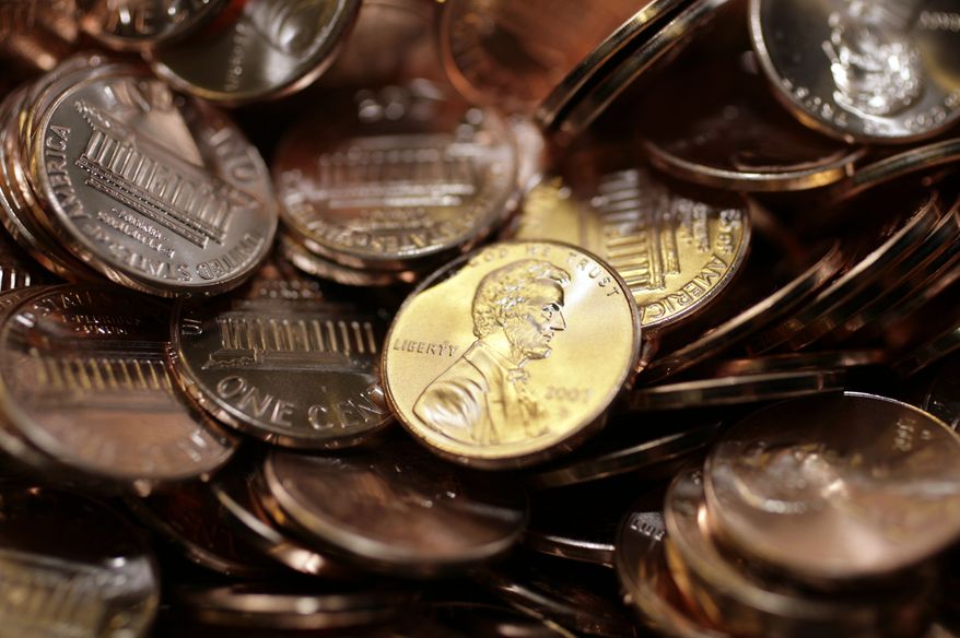 Freshly made pennies gleam under the lights as they sat in a bin at the U.S. Mint in Denver on Wednesday, Aug. 15, 2007. (AP Photo/David Zalubowski)
