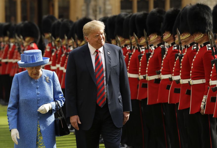 FILE - President Donald Trump and Britain's Queen Elizabeth II inspect a Guard of Honour, formed of the Coldstream Guards at Windsor Castle in Windsor, England, July 13, 2018. (AP Photo/Matt Dunham, Pool, File)