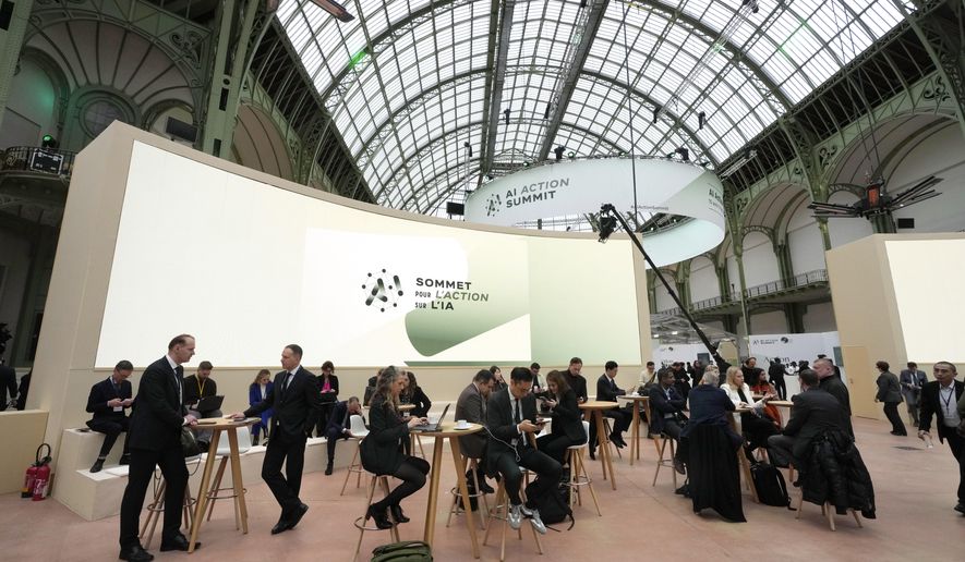 Attendees gather in a common space during an Artificial Intelligence Action Summit at the Grand Palais in Paris, Monday, Feb. 10, 2025. (AP Photo/Michel Euler)