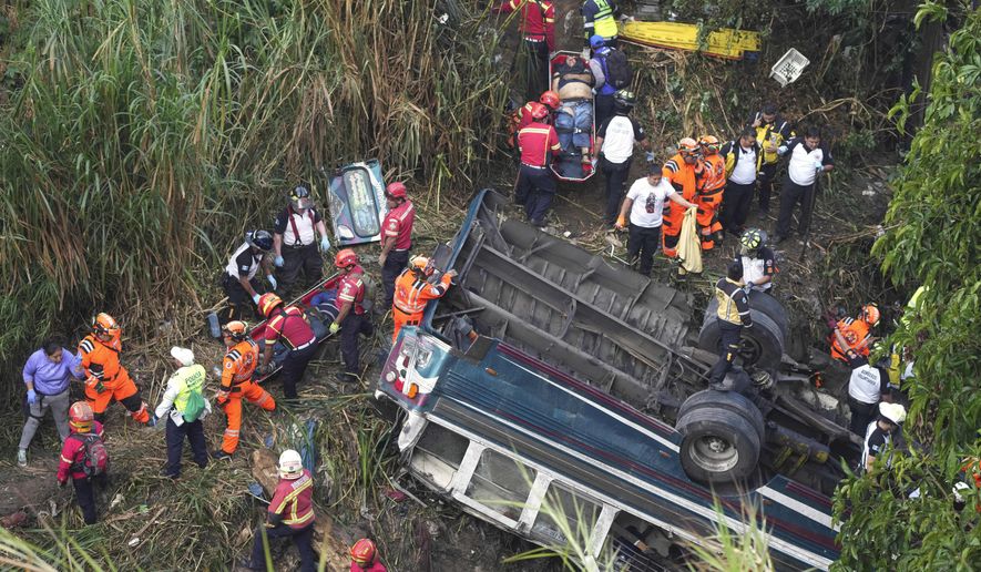 Firefighters work the scene of a fatal bus crash after it fell from a bridge on the outskirts of Guatemala City, Monday, Feb. 10, 2025. (AP Photo/Moises Castillo)