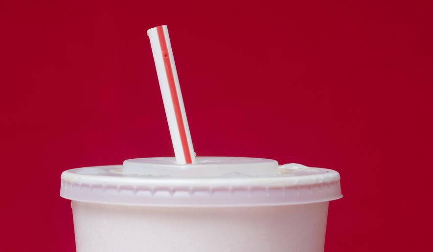 FILE- A large soft drink with a plastic straw from a McDonald's restaurant is shown in Surfside, Fla., May 24, 2018. (AP Photo/Wilfredo Lee, File)