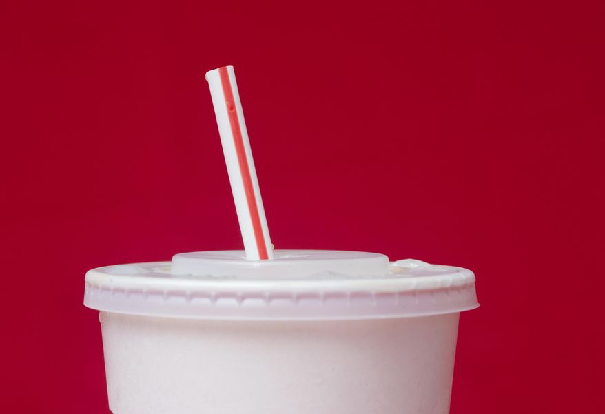 FILE- A large soft drink with a plastic straw from a McDonald's restaurant is shown in Surfside, Fla., May 24, 2018. (AP Photo/Wilfredo Lee, File)