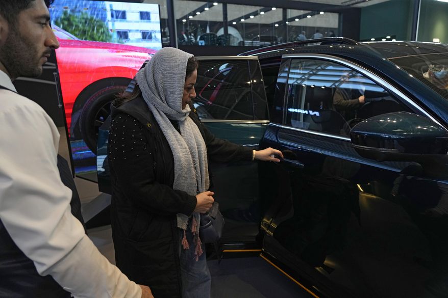 A visitor looks at a car on display at the 6th International Tehran Auto Show and related industries, just outside Tehran, Iran, Thursday, Jan. 30, 2025. (AP Photo/Vahid Salemi) ** FILE **