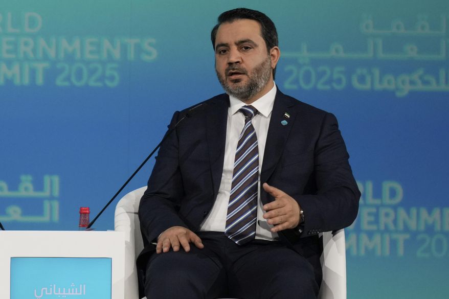 Syria's Interim Foreign Minister Asaad Al-Shibani talks to Kuwaiti journalist Ammar Taqi during the World Governments Summit in Dubai, United Arab Emirates, Wednesday, Feb. 12, 2025. (AP Photo/Altaf Qadri)