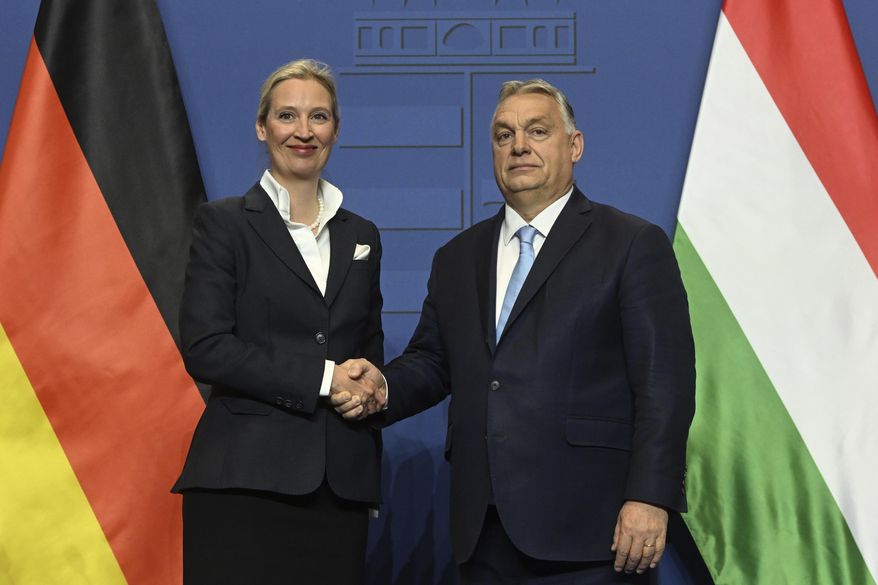 Alice Weidel, the Alternative for Germany (AfD) party's candidate for chancellor, left, and Hungarian Prime Minister Viktor Orban shake hands during a press conference following their meeting in the government headquarters in Budapest, Hungary, Wednesday, Feb. 12, 2025. (Szilard Koszticsak/MTI via AP)