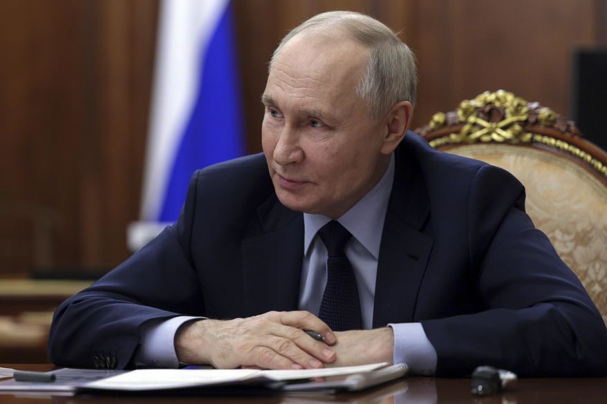 Russian President Vladimir Putin listens to acting Governor of the Kursk Region Alexander Khinshtein during their meeting at the Kremlin in Moscow, Russia, Wednesday, Feb. 5, 2025. (Gavriil Grigorov, Sputnik, Kremlin Pool Photo via AP)