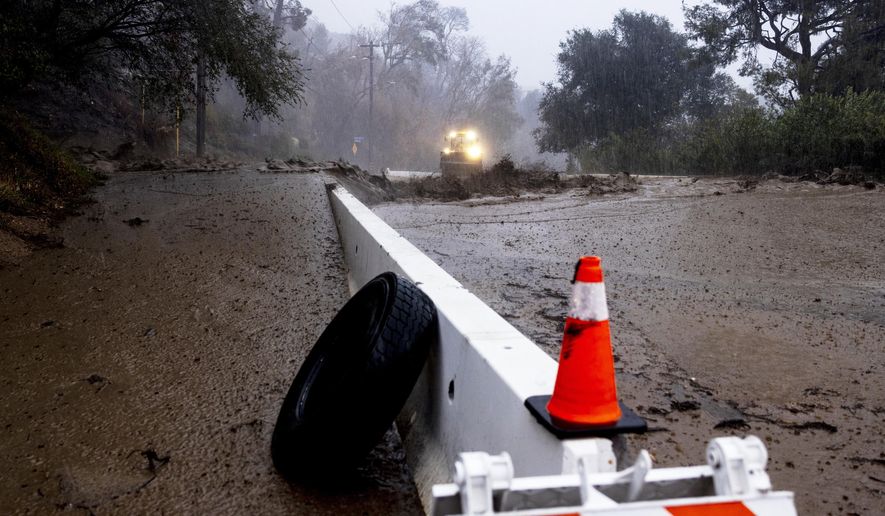 A road is covered in mud in the Eaton Fire zone during a storm Thursday, Feb. 13, 2025, in Altadena, Calif. (AP Photo/Etienne Laurent)