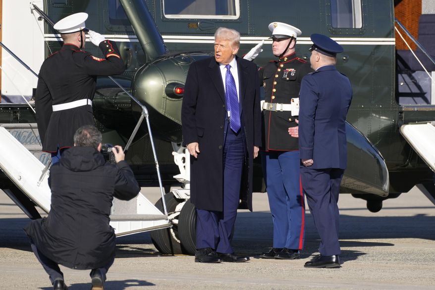 President Donald Trump, center, arrives on Marine One to board Air Force One at Joint Base Andrews, Md., Friday, Feb. 14, 2025, en route to West Palm Beach, Fla. (AP Photo/Ben Curtis)